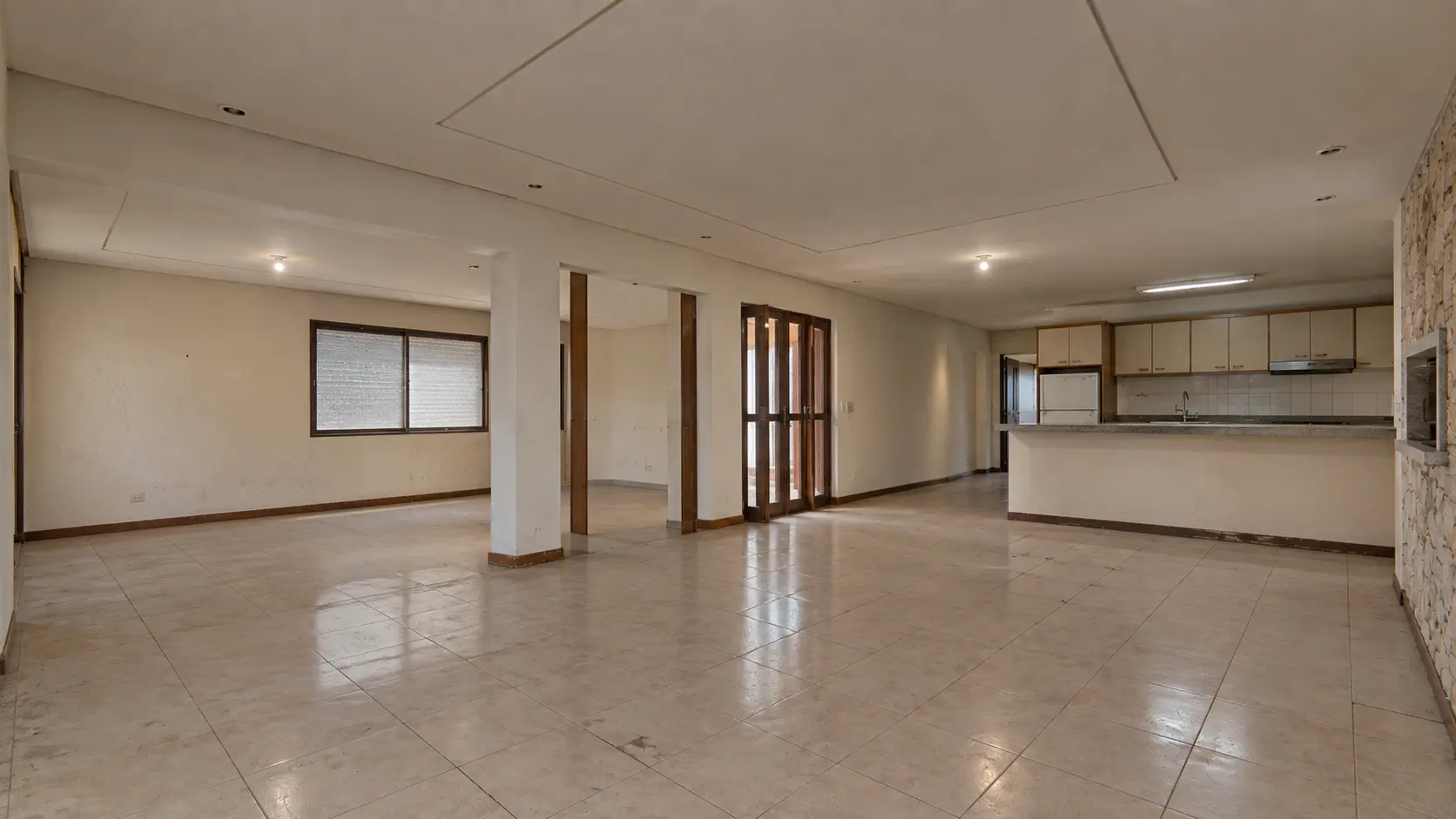 Sala antes da reforma, com paredes desgastadas e contrapiso exposto